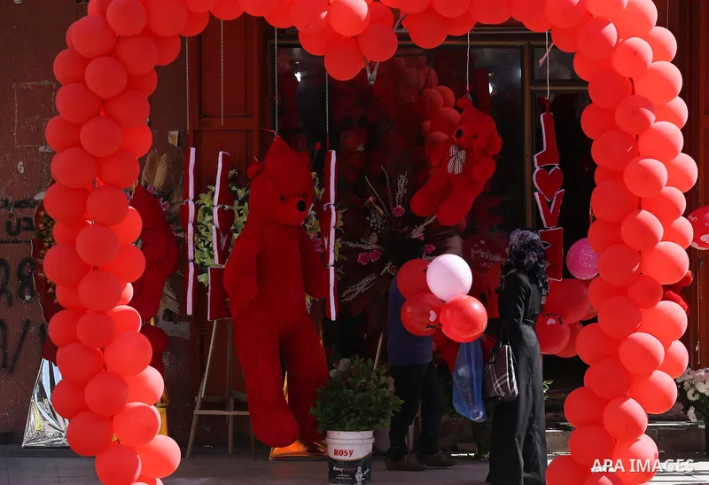 Palestinian vendors display flowers red teddy bears and pillows on Valentine's day in Gaza on February 14, 2016. Valentine's Day is increasingly popular in the region as people have taken up the custom of giving flowers,...