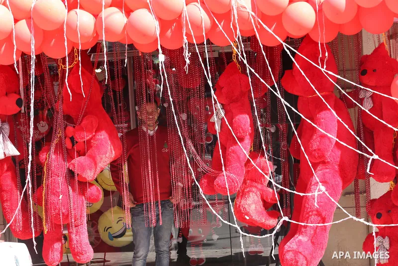Palestinian vendors display flowers red teddy bears and pillows on Valentine's day in Gaza on February 14, 2016. Valentine's Day is increasingly popular in the region as people have taken up the custom of giving flowers,...