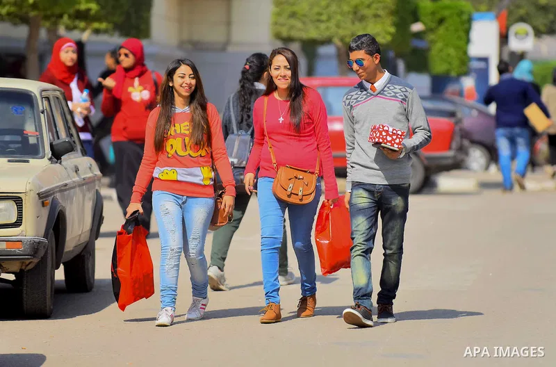 Egyptian students celebrate on Valentine's day at Cairo University, in Cairo on February 14, 2016. Valentine's Day is increasingly popular in the region as people have taken up the custom of giving flowers, cards, chocol...