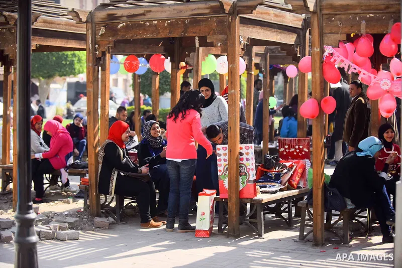 Egyptian students celebrate on Valentine's day at Cairo University, in Cairo on February 14, 2016. Valentine's Day is increasingly popular in the region as people have taken up the custom of giving flowers, cards, chocol...