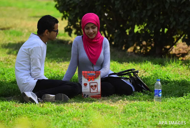Egyptian students celebrate on Valentine's day at Cairo University, in Cairo on February 14, 2016. Valentine's Day is increasingly popular in the region as people have taken up the custom of giving flowers, cards, chocol...