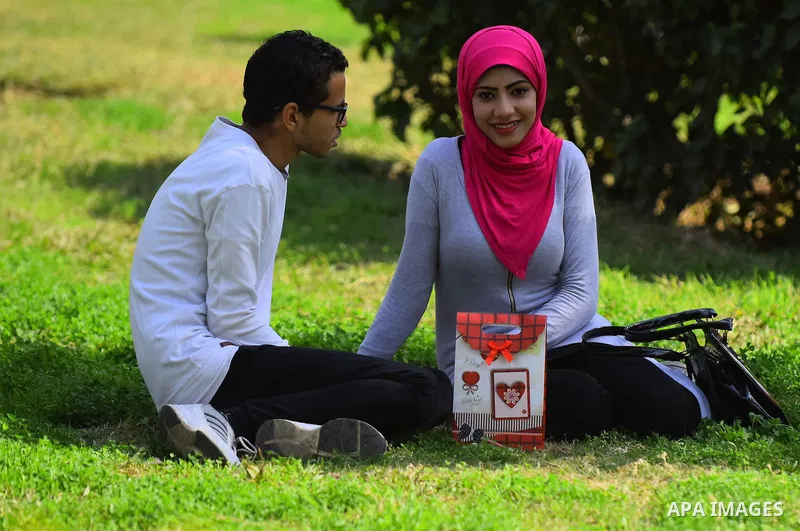 Egyptian students celebrate on Valentine's day at Cairo University, in Cairo on February 14, 2016. Valentine's Day is increasingly popular in the region as people have taken up the custom of giving flowers, cards, chocol...