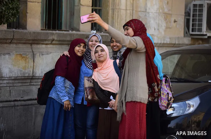 Egyptian students celebrate on Valentine's day at Cairo University, in Cairo on February 14, 2016. Valentine's Day is increasingly popular in the region as people have taken up the custom of giving flowers, cards, chocol...