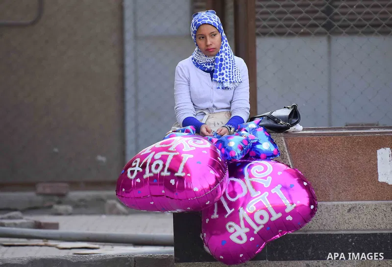 Egyptian students celebrate on Valentine's day at Cairo University, in Cairo on February 14, 2016. Valentine's Day is increasingly popular in the region as people have taken up the custom of giving flowers, cards, chocol...