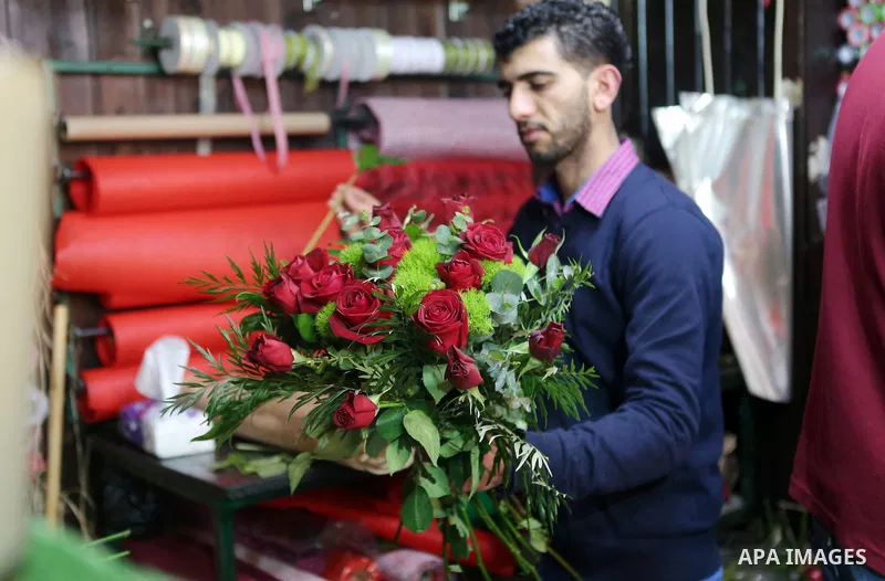 Palestinian vendors display flowers red teddy bears and pillows on Valentine's day in the West Bank city of Ramallah, on February 14, 2016. Valentine's Day is increasingly popular in the region as people have taken up th...