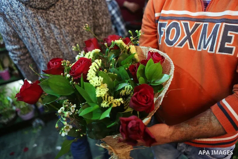 Palestinian vendors display flowers red teddy bears and pillows on Valentine's day in the West Bank city of Ramallah, on February 14, 2016. Valentine's Day is increasingly popular in the region as people have taken up th...