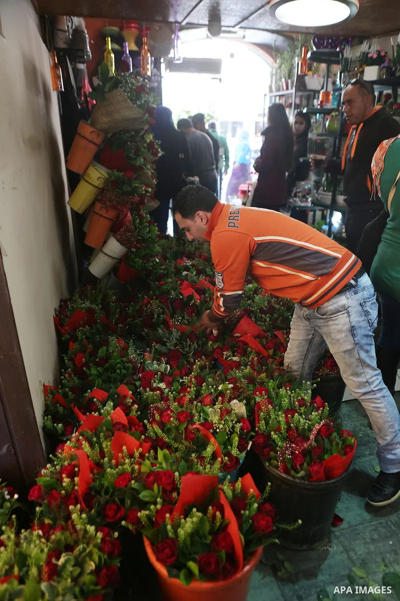 Palestinian vendors display flowers red teddy bears and pillows on Valentine's day in the West Bank city of Ramallah, on February 14, 2016. Valentine's Day is increasingly popular in the region as people have taken up th...