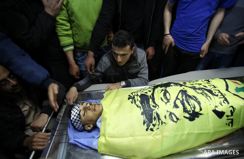 Relatives of Palestinian Nihad Waked who was shot dead by Israeli security forces as they reported fired on Israeli soldiers mourn over his body at the hospital on February 14, 2016 in the village of Araka, West of Jenin...