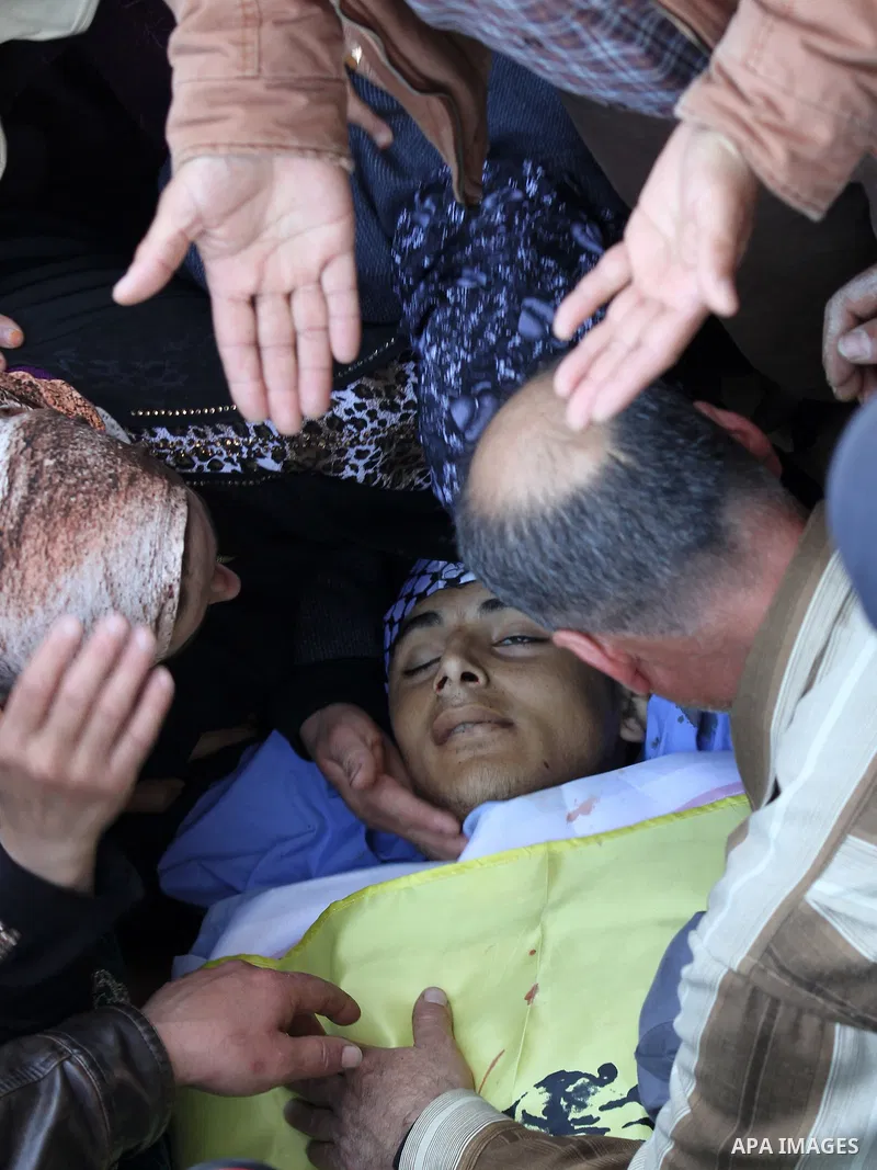Relatives of Palestinian Nihad Waked who was shot dead by Israeli security forces as they reported fired on Israeli soldiers mourn over his body during his funeral on February 14, 2016 in the village of Araka, West of Je...