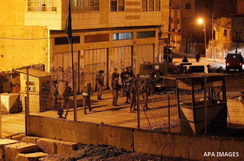 Israeli security forces gather near the scene where a Palestinian girl was shot and injured following a reported stabbing attack near the Ibrahimi mosque, or the Tomb of the Patriarch, a religious site to both Muslims an...