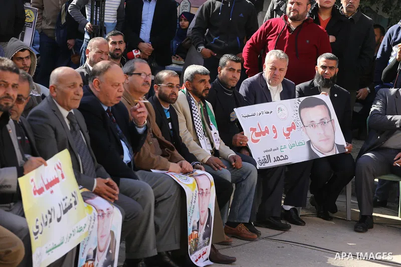 Palestinians hold posters during a protest in support of hunger striking Palestinian journalist Mohammed al-Qiq, in front of the Red cross office, Gaza city on February 14, 2016. The 33-year-old television reporter will...
