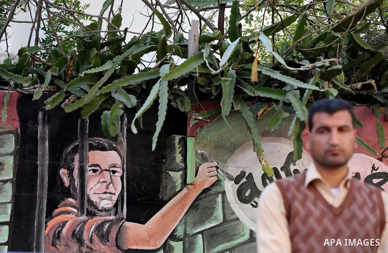 Palestinians hold posters during a protest in support of hunger striking Palestinian journalist Mohammed al-Qiq, in front of the Red cross office, Gaza city on February 14, 2016. The 33-year-old television reporter will...