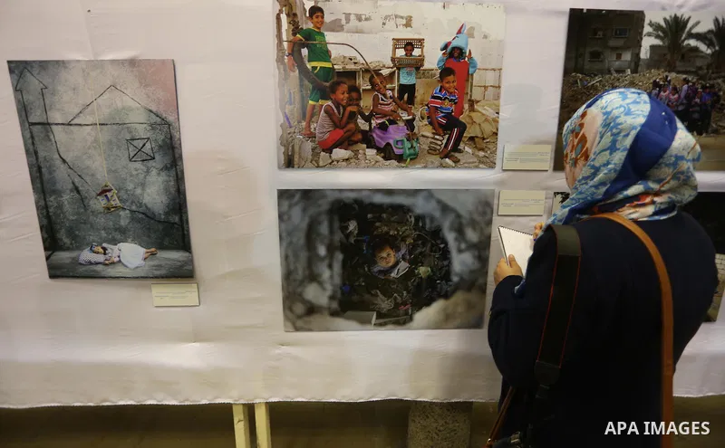 Palestinians attend a photo gallery organized by the Relief and Works Agency "UNRWA", in Gaza city on |Feb. 15, 2016. Photo by Mohammed Asad