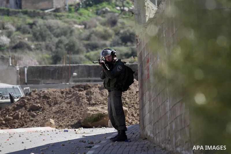 A member of Israeli security forces stands in position during clashes with Palestinian protesters in the village of Araka, West of Jenin in the Israeli occupied West Bank on February 15, 2016. Photo by Nedal Eshtayah