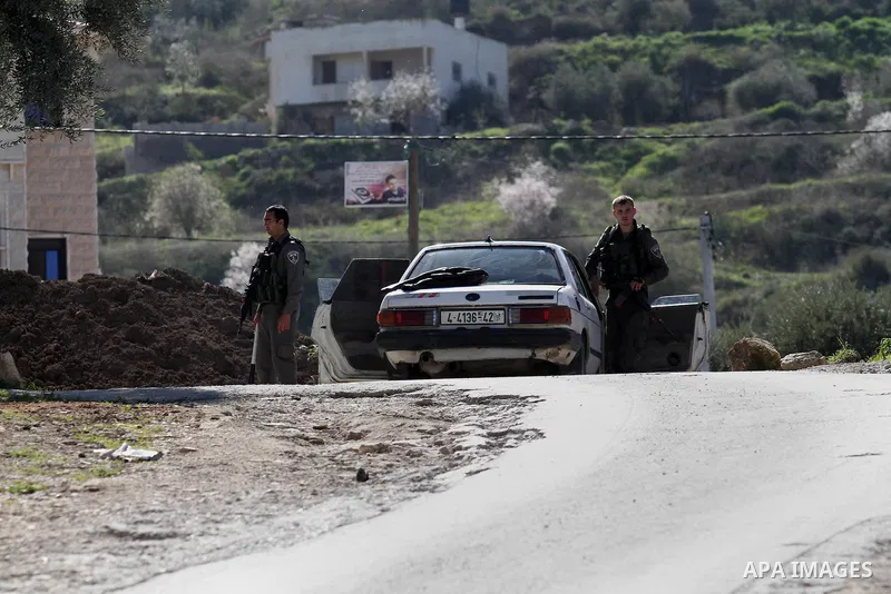 Israeli security forces inspect a car during clashes with Palestinian protesters in the village of Araka, West of Jenin in the Israeli occupied West Bank on February 15, 2016. Photo by Nedal Eshtayah