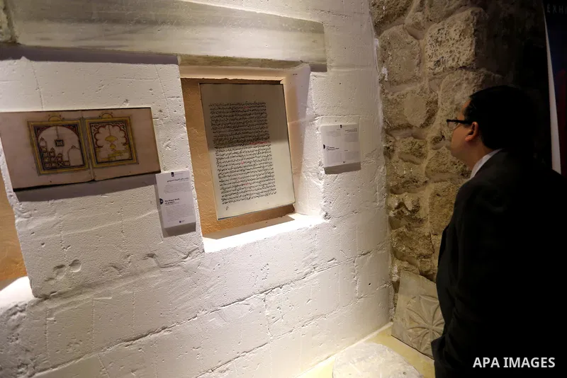 Palestinians attend the Islamic art gallery organized by the Dutch embassy in Gaza city on Feb. 16, 2016. Photo by Mohammed Asad