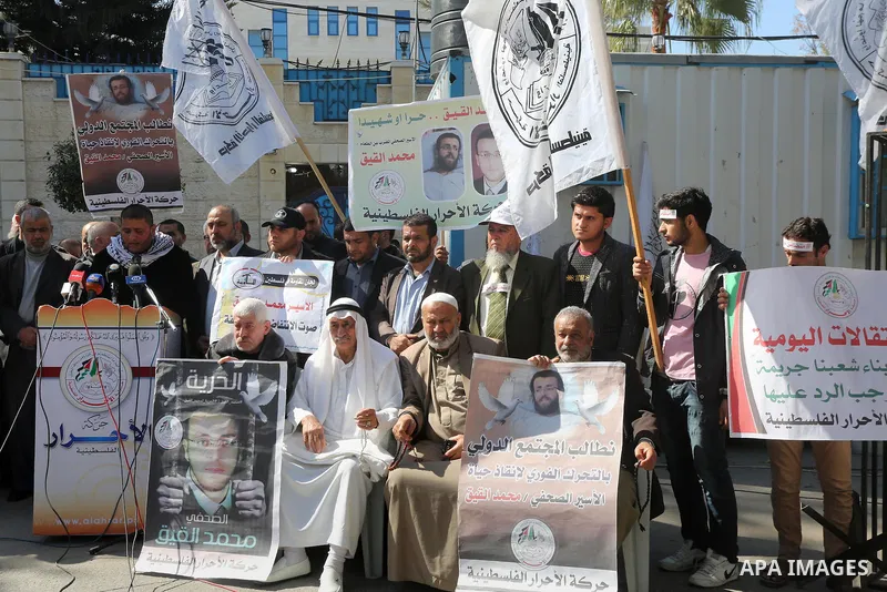 Palestinians hold posters during a protest in support of hunger striking Palestinian journalist Mohammed al-Qiq, in Gaza city on February 17, 2016. Israel's top court rejected Qiq's request to be moved to the West Bank f...