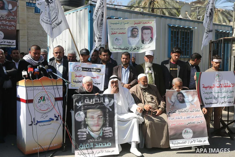 Palestinians hold posters during a protest in support of hunger striking Palestinian journalist Mohammed al-Qiq, in Gaza city on February 17, 2016. Israel's top court rejected Qiq's request to be moved to the West Bank f...