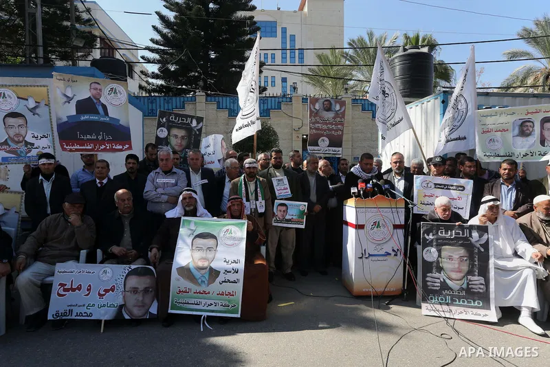 Palestinians hold posters during a protest in support of hunger striking Palestinian journalist Mohammed al-Qiq, in Gaza city on February 17, 2016. Israel's top court rejected Qiq's request to be moved to the West Bank f...