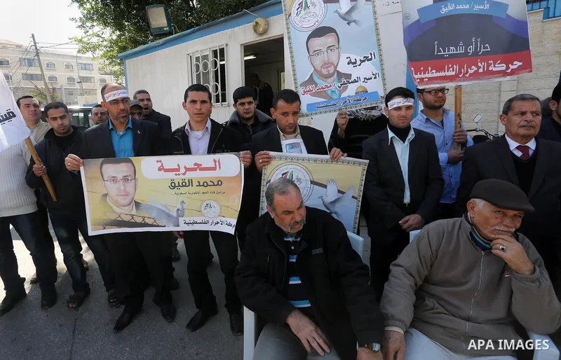 Palestinians hold posters during a protest in support of hunger striking Palestinian journalist Mohammed al-Qiq, in Gaza city on February 17, 2016. Israel's top court rejected Qiq's request to be moved to the West Bank f...