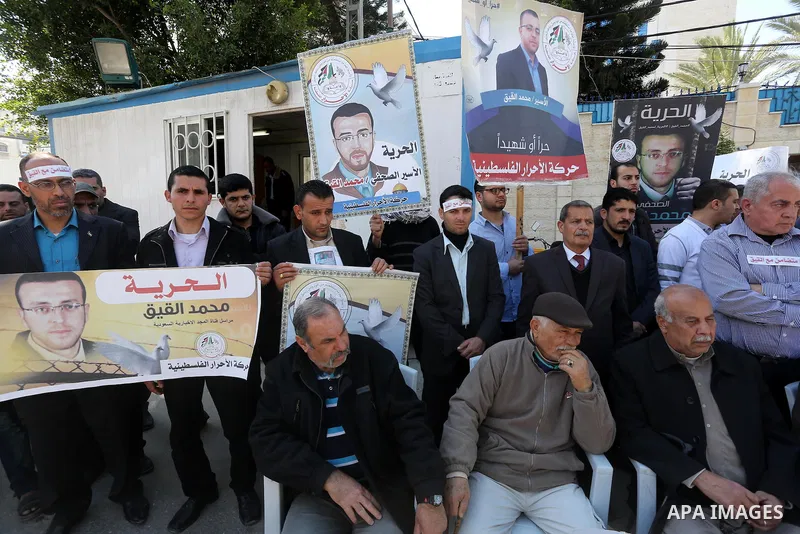 Palestinians hold posters during a protest in support of hunger striking Palestinian journalist Mohammed al-Qiq, in Gaza city on February 17, 2016. Israel's top court rejected Qiq's request to be moved to the West Bank f...