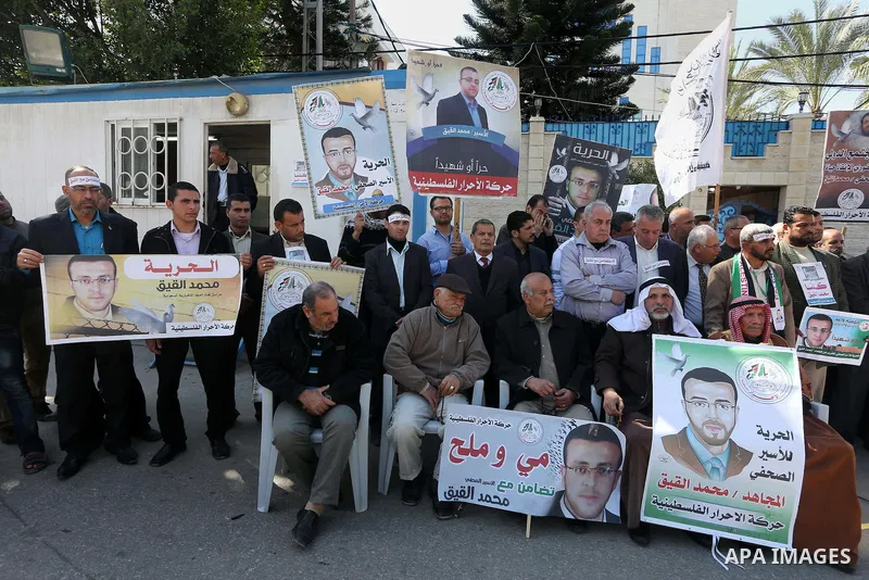 Palestinians hold posters during a protest in support of hunger striking Palestinian journalist Mohammed al-Qiq, in Gaza city on February 17, 2016. Israel's top court rejected Qiq's request to be moved to the West Bank f...
