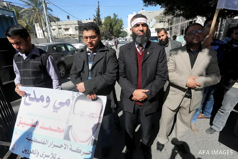 Palestinians hold posters during a protest in support of hunger striking Palestinian journalist Mohammed al-Qiq, in Gaza city on February 17, 2016. Israel's top court rejected Qiq's request to be moved to the West Bank f...