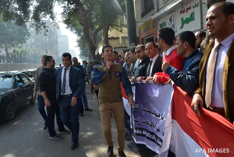 Egyptians take part in a protest to demand jobs in front of the Council of Ministers, in Cairo, Egypt, on February 17, 2016. Photo by Amr Sayed