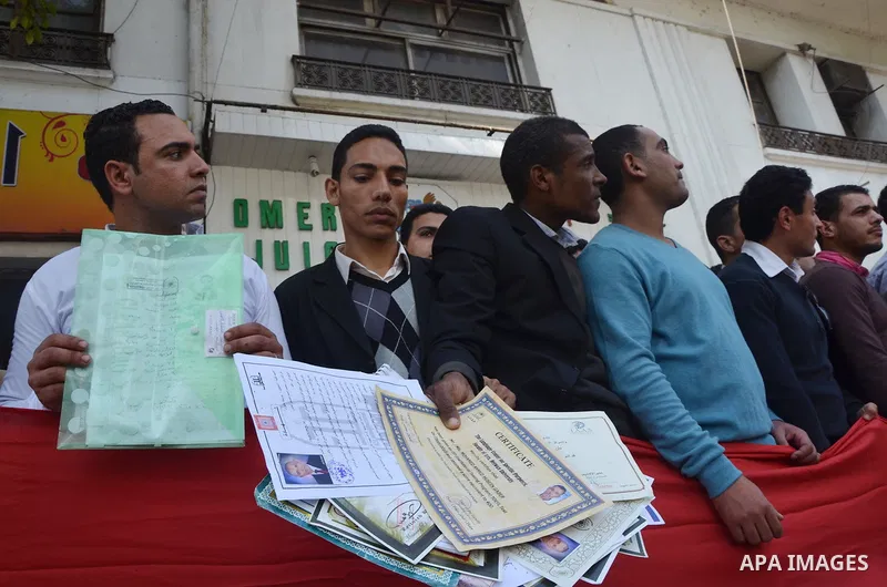 Egyptians take part in a protest to demand jobs in front of the Council of Ministers, in Cairo, Egypt, on February 17, 2016. Photo by Amr Sayed