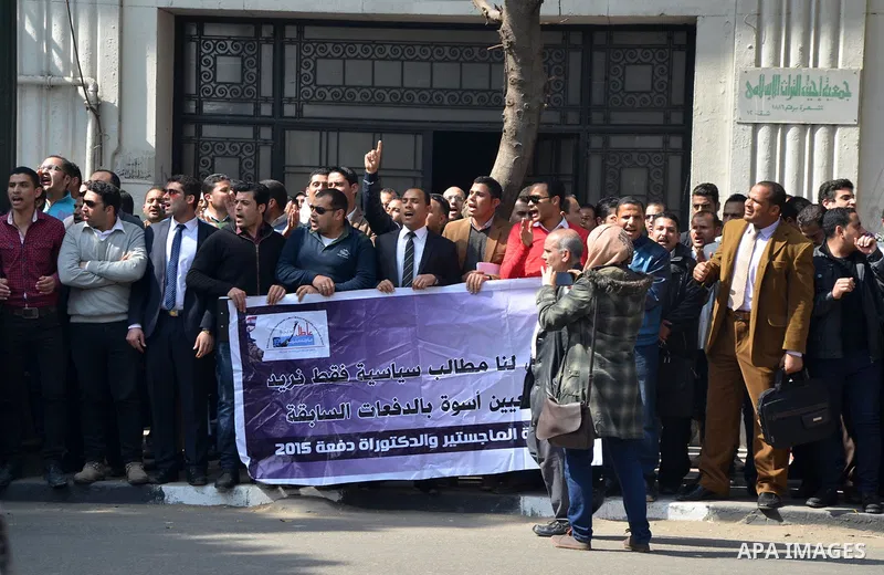 Egyptians take part in a protest to demand jobs in front of the Council of Ministers, in Cairo, Egypt, on February 17, 2016. Photo by Amr Sayed