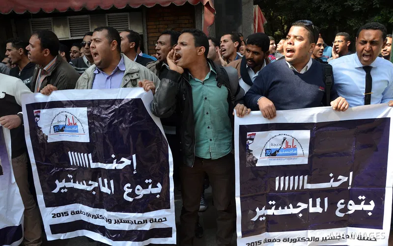 Egyptians take part in a protest to demand jobs in front of the Council of Ministers, in Cairo, Egypt, on February 17, 2016. Photo by Amr Sayed