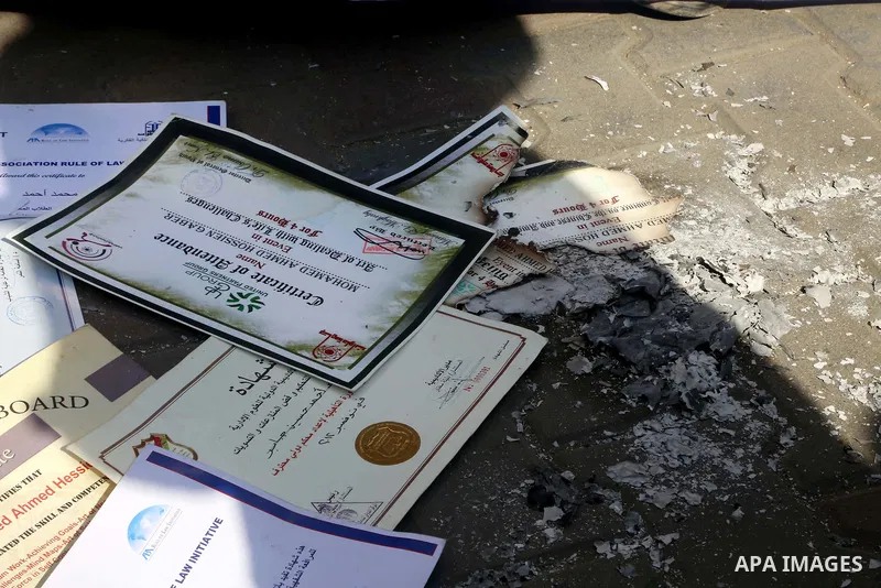 Egyptians burn their certificate of Master's and Ph.D. during a protest to demand jobs in front of the journalists syndicate, in Cairo, Egypt, on February 17, 2016. Photo by Alaa Elkassas