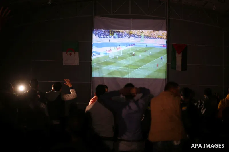 Palestinian fans watch on giant screens a friendly football match between Palestinian team and Algeria's team in Gaza city on Feb. 17, 2016. Photo by Mohammed Asad