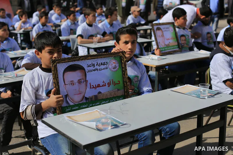 Palestinian students take part in a demonstration calling for the release of Mohammed al-Qiq, a Palestinian prisoner on hunger strike, in front of Red cross office in Gaza city, on February 18, 2016. Israel's top court r...