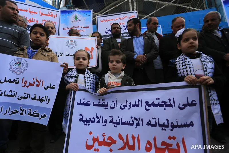 Palestinians take part in a protest against reductions of the services and aid offered by United Nations Relief and Works Agency (UNRWA), in front of UNRWA headquarters in Gaza City on February 18, 2016. Photo by Yasser...