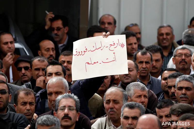 Palestinian teachers take part in a protest to demand their rights, in the West bank city of Hebron, on February 18, 2016. Photo by Wisam Hashlamoun