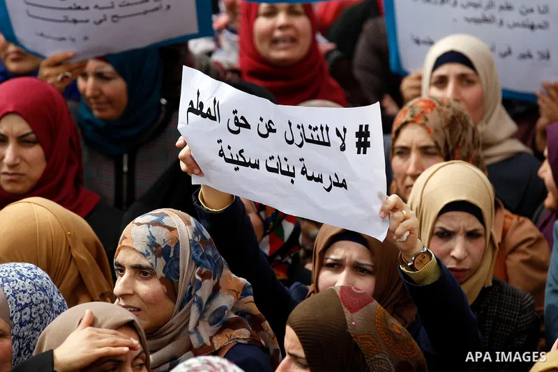 Palestinian teachers take part in a protest to demand their rights, in the West bank city of Hebron, on February 18, 2016. Photo by Wisam Hashlamoun