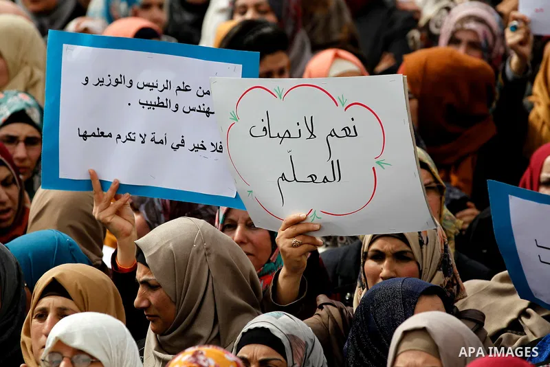 Palestinian teachers take part in a protest to demand their rights, in the West bank city of Hebron, on February 18, 2016. Photo by Wisam Hashlamoun