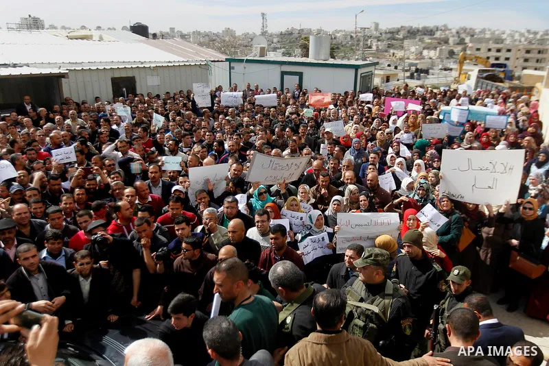 Palestinian teachers take part in a protest to demand their rights, in the West bank city of Hebron, on February 18, 2016. Photo by Wisam Hashlamoun