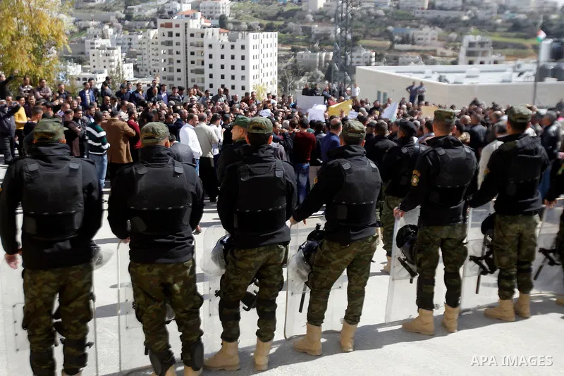 Palestinian teachers take part in a protest to demand their rights, in the West bank city of Hebron, on February 18, 2016. Photo by Wisam Hashlamoun