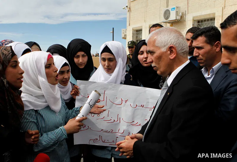 Palestinian teachers take part in a protest to demand their rights, in the West bank city of Hebron, on February 18, 2016. Photo by Wisam Hashlamoun