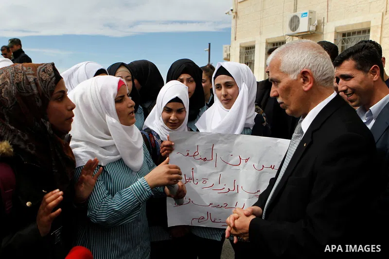 Palestinian teachers take part in a protest to demand their rights, in the West bank city of Hebron, on February 18, 2016. Photo by Wisam Hashlamoun