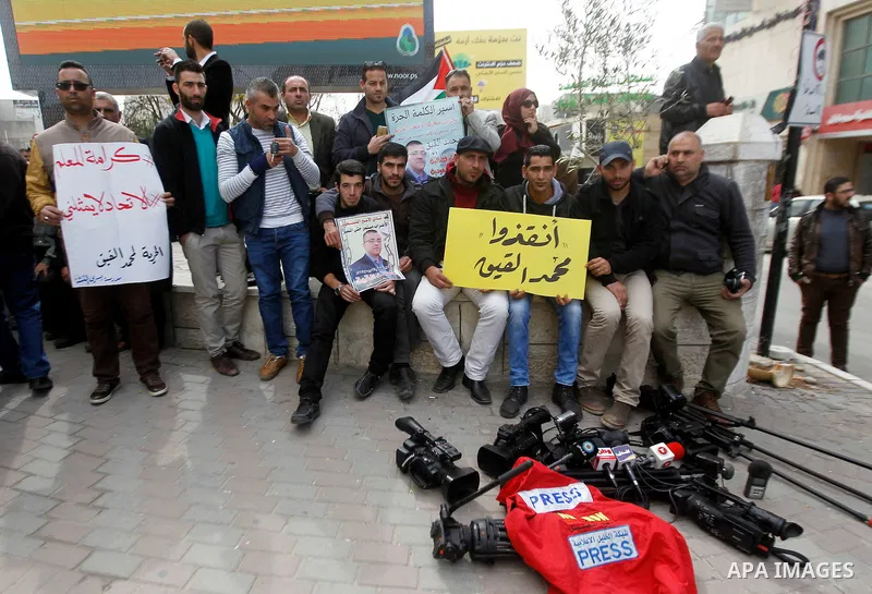 Palestinian Journalists take part in a demonstration calling for the release of Mohammed al-Qiq, a Palestinian prisoner on hunger strike, in the West bank city of Hebron on February 18, 2016. Israel's top court rejected...