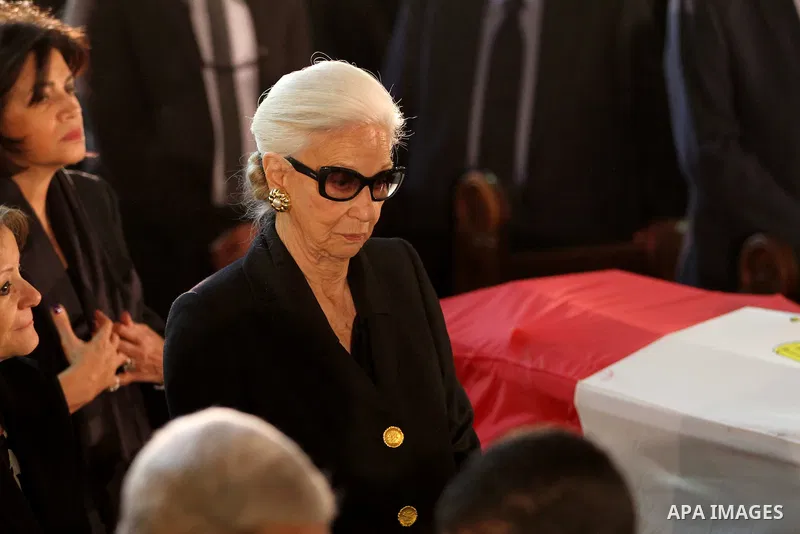 Leia Boutros-Ghali (L), the wife of former UN secretary-general Boutros Boutros-Ghali sits next to her husbands coffin draped in the Egyptian flag during his funeral at the St Peter and St Paul Coptic Orthodox church tha...