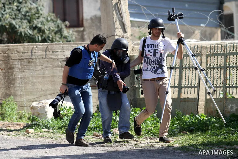 Palestinian Photographers help their fellow who wounded during clashes between Palestinian protesters and Israeli security forces following a demonstration against the expropriation of Palestinian land by Israel on Febru...