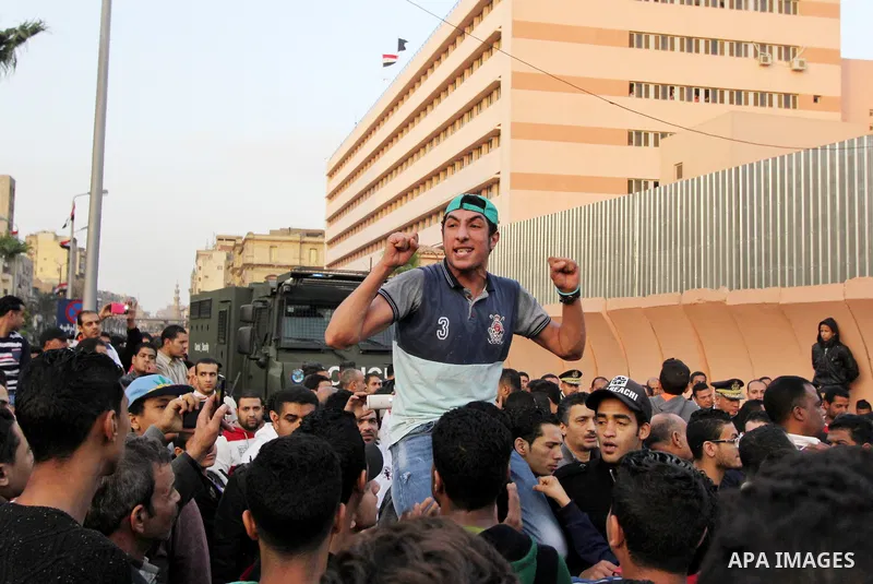 Egyptian Mourners protest the death of Mohamed Ali Sayed Ismail, a 23 year-old driver, who was shot dead overnight during a dispute with a police sergeant, ouside local security headquarters in Cairo, Egypt, Friday, Feb....
