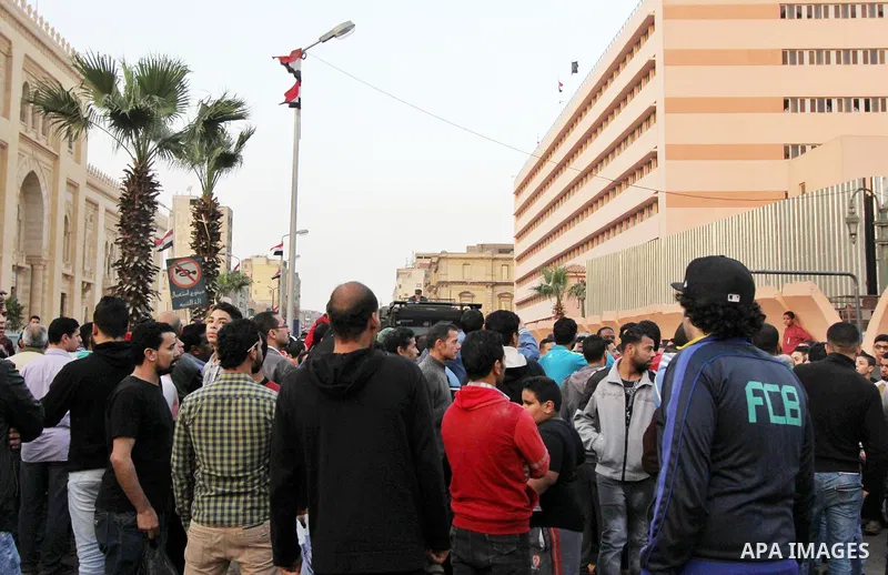 Egyptian Mourners protest the death of Mohamed Ali Sayed Ismail, a 23 year-old driver, who was shot dead overnight during a dispute with a police sergeant, ouside local security headquarters in Cairo, Egypt, Friday, Feb....