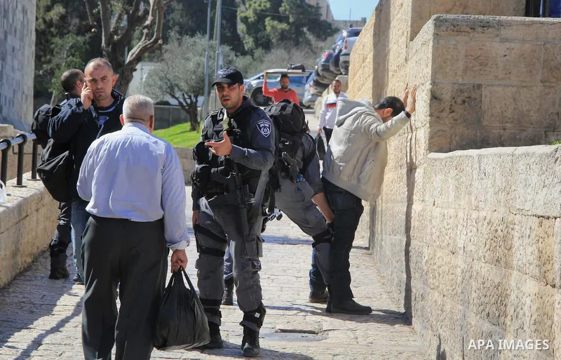 Israeli border policeman searches a Palestinian at the Old City's Damascus Gate in Jerusalem Friday, Feb. 19, 2016. The Damascus Gate has been the scene of numerous Palestinian attacks over the past few months and Israel...