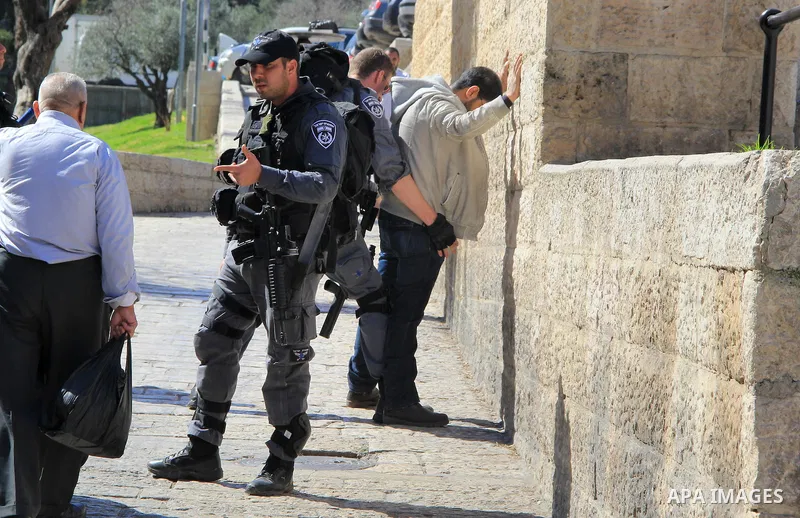 Israeli border policeman searches a Palestinian at the Old City's Damascus Gate in Jerusalem Friday, Feb. 19, 2016. The Damascus Gate has been the scene of numerous Palestinian attacks over the past few months and Israel...