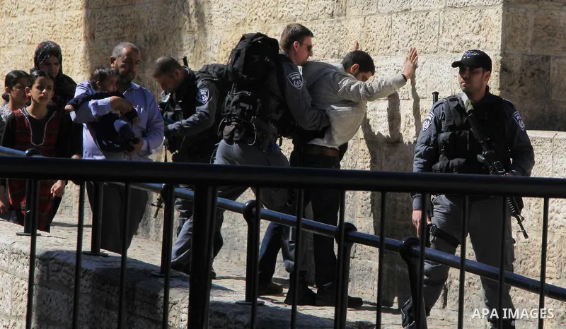 Israeli border policeman searches a Palestinian at the Old City's Damascus Gate in Jerusalem Friday, Feb. 19, 2016. The Damascus Gate has been the scene of numerous Palestinian attacks over the past few months and Israel...
